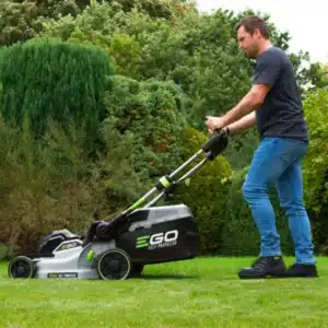 Muž kosí trávnik s kosačkou EGO 52cm s pojazdom.